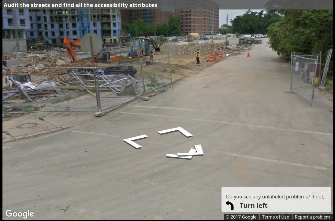 A Street View image of a long stretch of sidewalk under construction