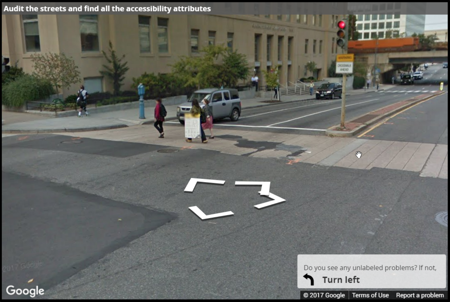 A Street View image of a crosswalk with surface problems