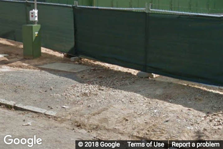 A Street View image of a gravel sidewalk